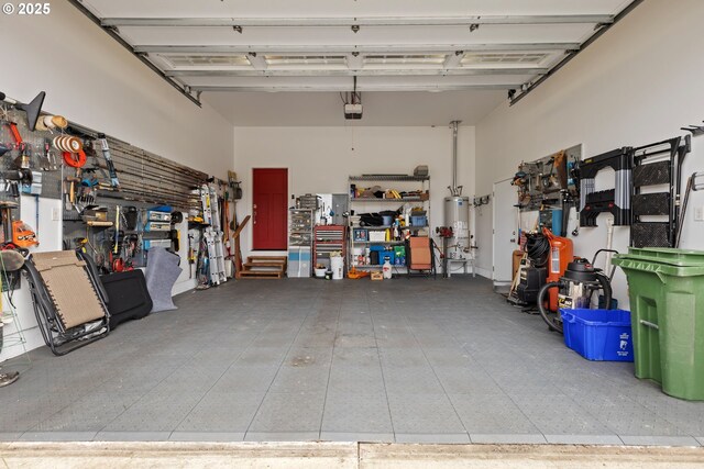 garage with water heater and a garage door opener