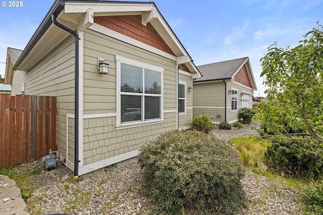 view of home's exterior with fence