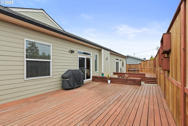 deck with grilling area and fence