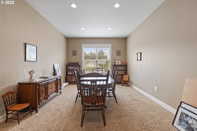 dining room featuring light colored carpet, baseboards, and recessed lighting