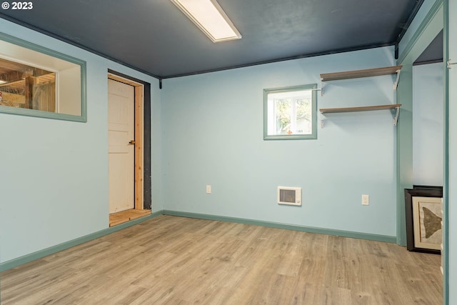 unfurnished bedroom featuring baseboards, light wood-style flooring, and visible vents