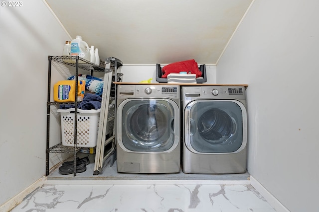 laundry room featuring laundry area, washer and clothes dryer, marble finish floor, and baseboards