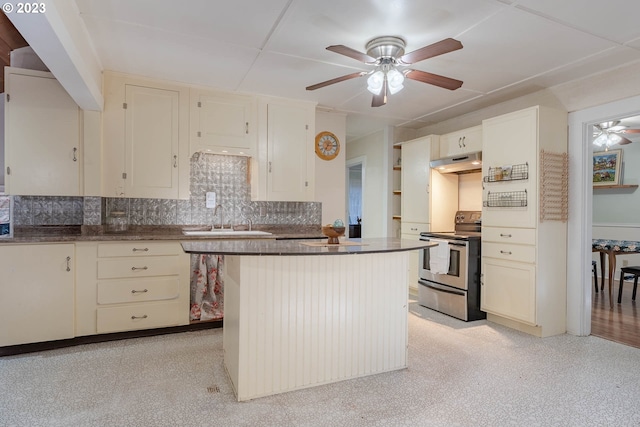 kitchen with a ceiling fan, tasteful backsplash, stainless steel range with electric cooktop, a sink, and under cabinet range hood