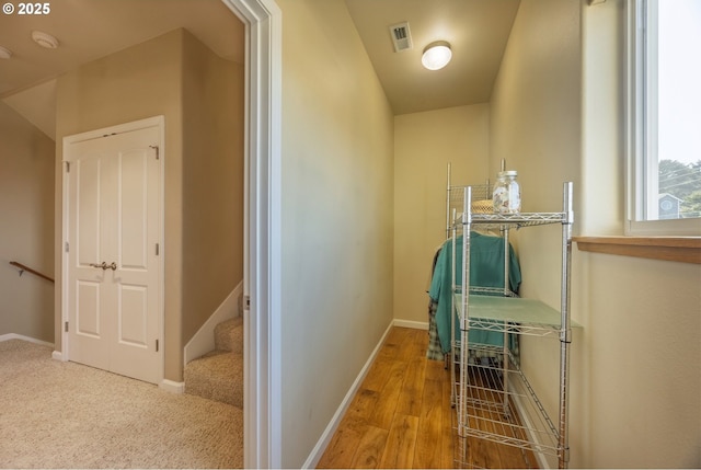 1587 NW 39th St, Lincoln City, OR 97367 - corridor featuring baseboards, wood finished floors, and visible vents