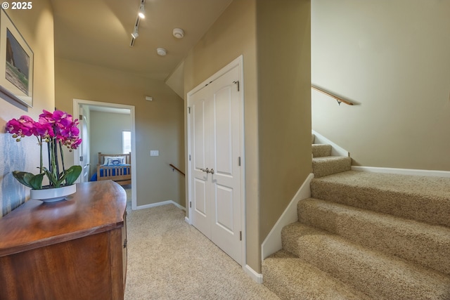 1587 NW 39th St, Lincoln City, OR 97367 - stairway with track lighting, carpet floors, and baseboards