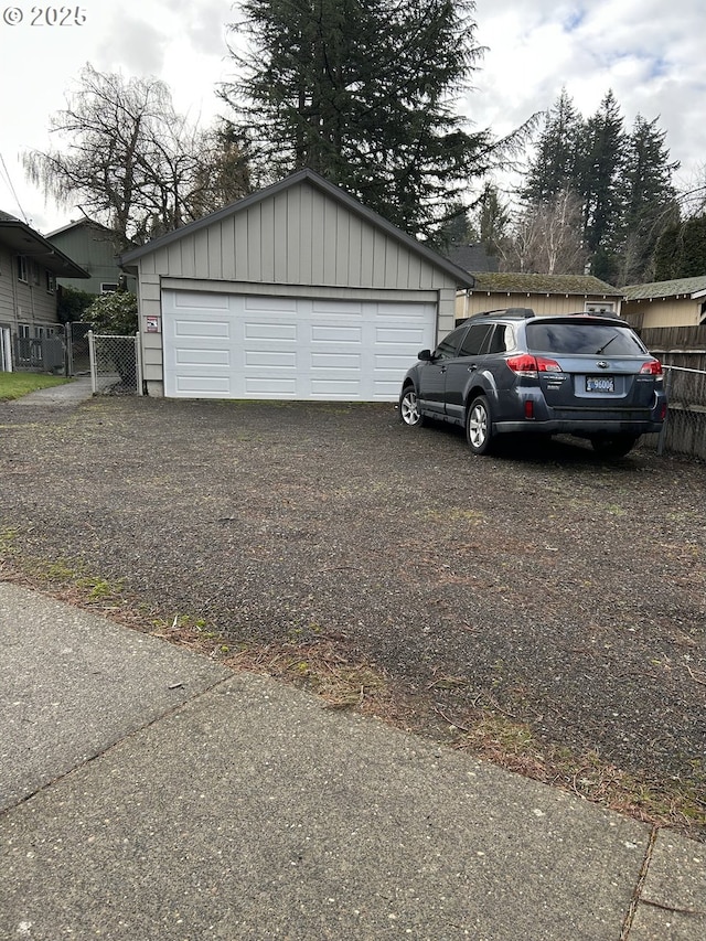 detached garage featuring fence