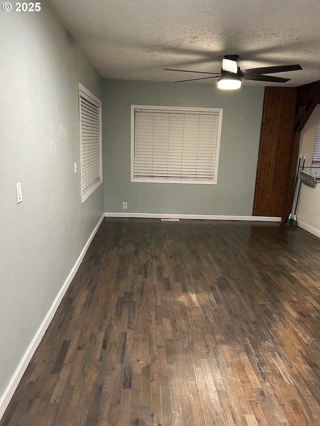 unfurnished living room featuring a ceiling fan, a textured ceiling, baseboards, and wood finished floors