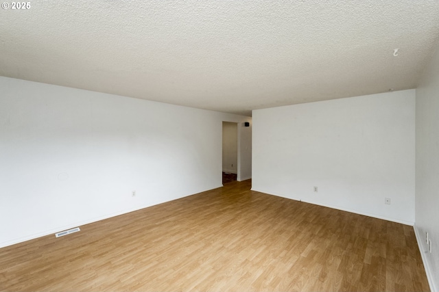730 SW Dolph St, Portland, OR 97219 - empty room featuring light wood-style floors and a textured ceiling