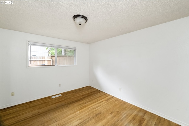730 SW Dolph St, Portland, OR 97219 - empty room featuring wood finished floors and baseboards