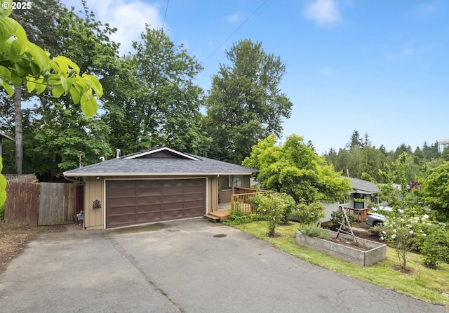 730 SW Dolph St, Portland, OR 97219 - view of front of home featuring a garage, a shingled roof, board and batten siding, and view of wooded area