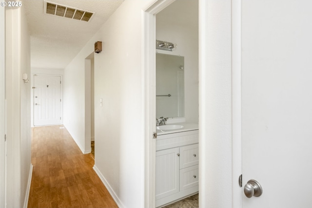 730 SW Dolph St, Portland, OR 97219 - hall featuring a sink and light wood-type flooring