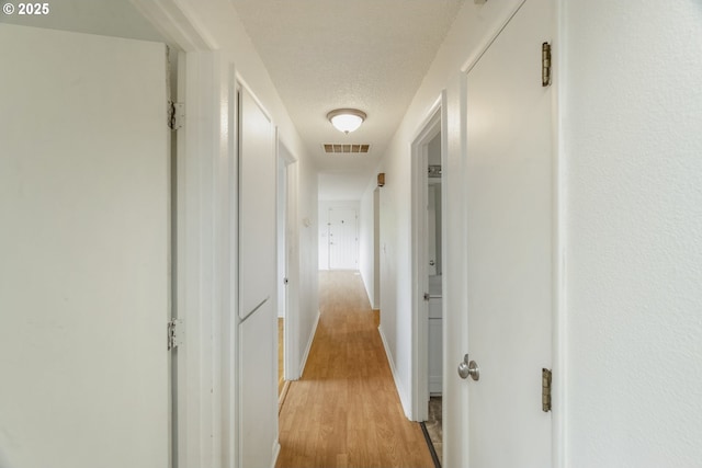 730 SW Dolph St, Portland, OR 97219 - corridor featuring light wood-style floors and a textured ceiling