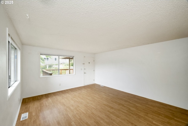 730 SW Dolph St, Portland, OR 97219 - empty room featuring wood finished floors and a textured ceiling