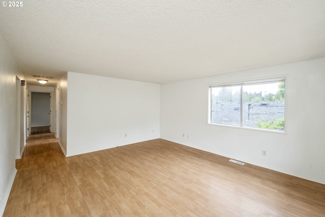 730 SW Dolph St, Portland, OR 97219 - spare room with wood finished floors and a textured ceiling
