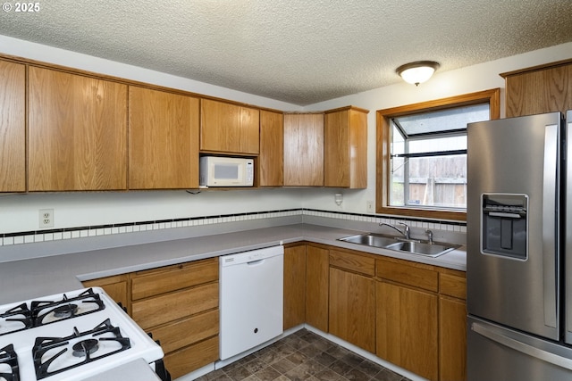 730 SW Dolph St, Portland, OR 97219 - kitchen featuring white appliances, brown cabinets, a textured ceiling, and light countertops