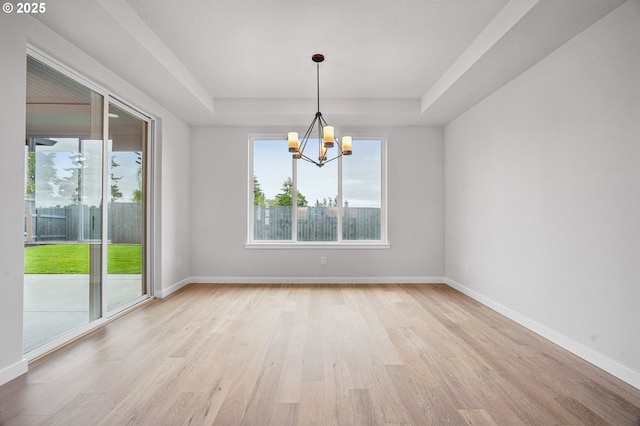 4321 N 11th Way, Ridgefield, WA 98642 - empty room featuring a tray ceiling, a chandelier, light wood-style flooring, and baseboards
