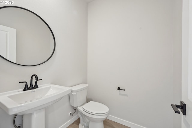 4321 N 11th Way, Ridgefield, WA 98642 - half bath featuring a sink, wood finished floors, toilet, and baseboards