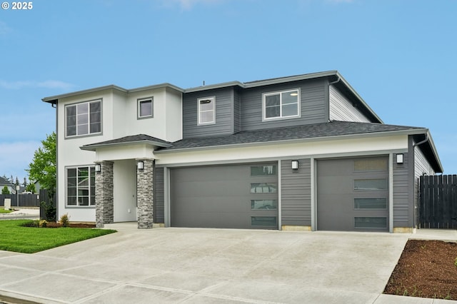 4321 N 11th Way, Ridgefield, WA 98642 - prairie-style house featuring driveway, fence, an attached garage, and a shingled roof