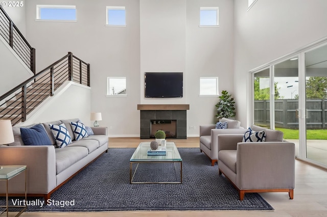 4321 N 11th Way, Ridgefield, WA 98642 - living area featuring a towering ceiling, wood finished floors, a tile fireplace, and stairway