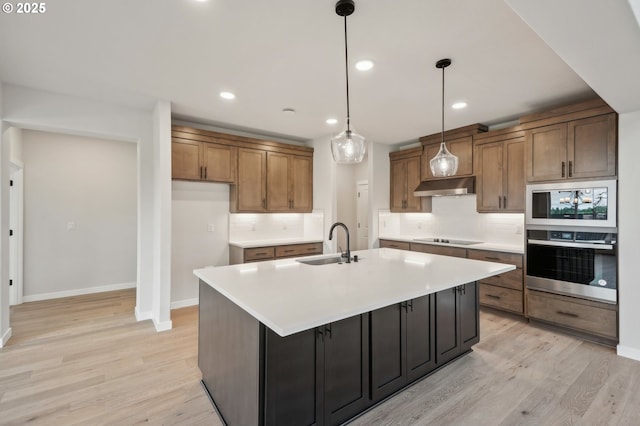 4321 N 11th Way, Ridgefield, WA 98642 - kitchen featuring stainless steel appliances, a sink, under cabinet range hood, tasteful backsplash, and recessed lighting