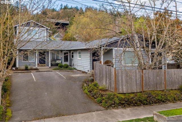 view of front of house featuring fence