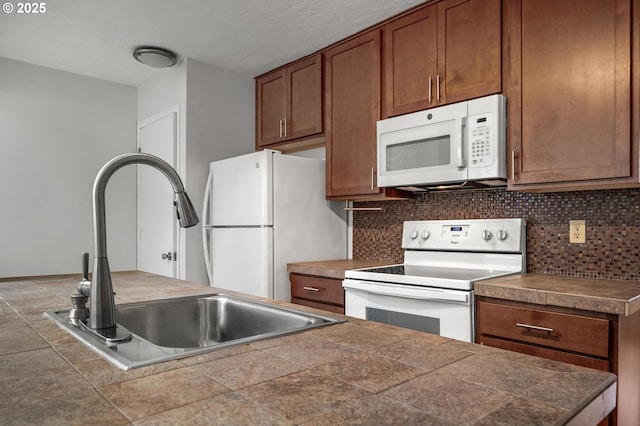 6125 S Hood Ave, Portland, OR 97239 - kitchen with decorative backsplash, brown cabinets, white appliances, and a sink