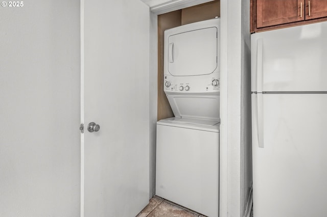 6125 S Hood Ave, Portland, OR 97239 - laundry room with light tile patterned floors, laundry area, and stacked washer / dryer