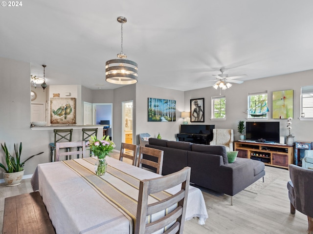 1170 NE 64th Ln Unit 1209, Hillsboro, OR 97124 - dining area with light wood-style floors, a chandelier, and ceiling fan