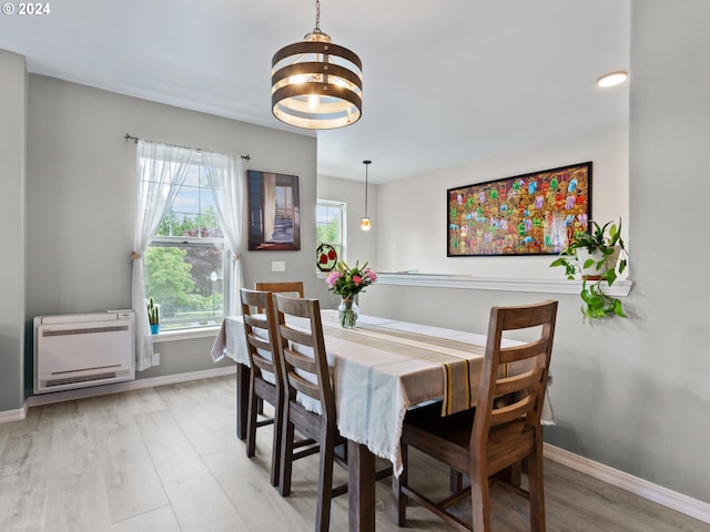 1170 NE 64th Ln Unit 1209, Hillsboro, OR 97124 - dining space featuring heating unit, a chandelier, and wood finished floors