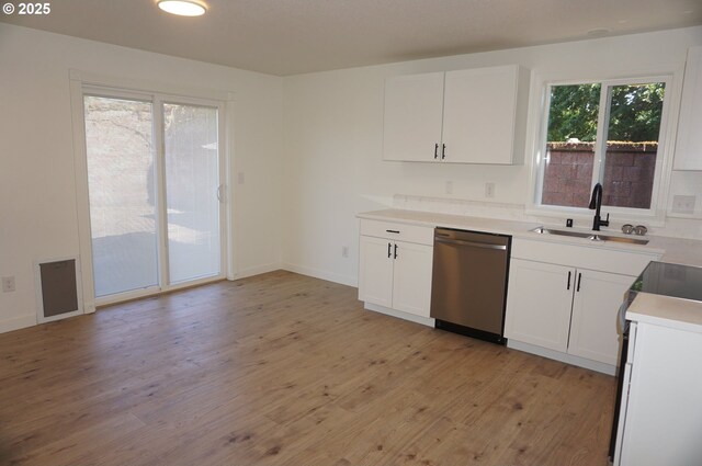7012 NE 149th Ct, Vancouver, WA 98682 - kitchen with stainless steel dishwasher, a sink, light wood-style floors, white cabinets, and electric stove