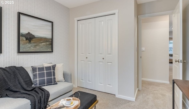 sitting room featuring baseboards and light colored carpet