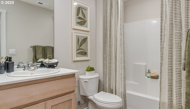 bathroom featuring toilet, vanity, and shower / tub combo