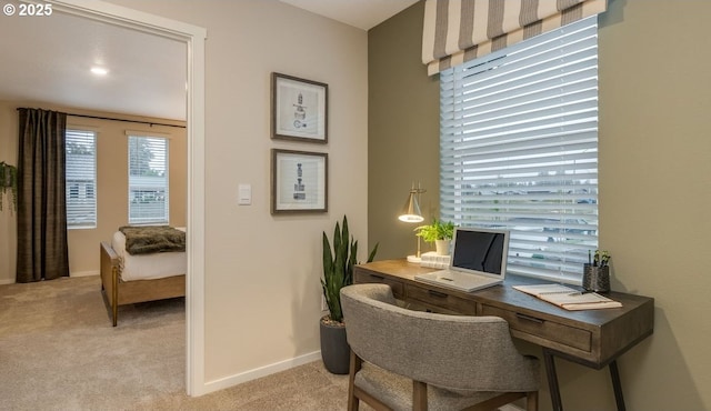 home office with light colored carpet and baseboards