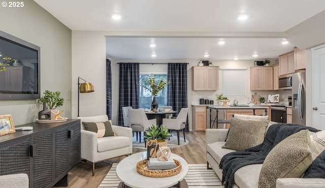 living room featuring light wood finished floors and recessed lighting