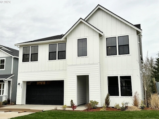 modern inspired farmhouse featuring a garage and a front lawn