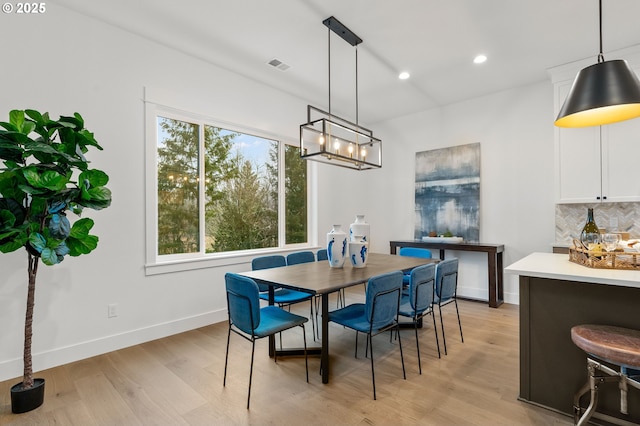 dining space with light hardwood / wood-style flooring