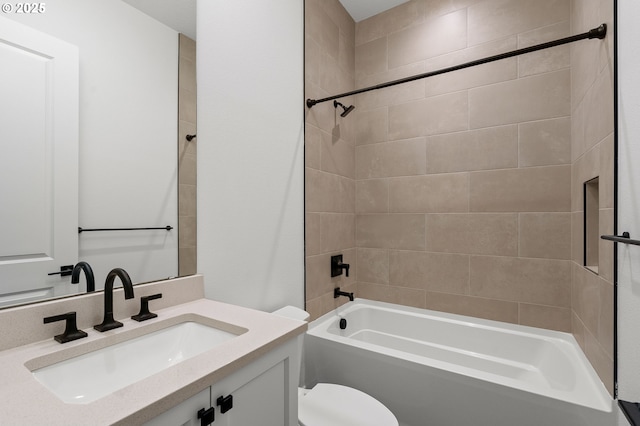 full bathroom featuring vanity, toilet, and tiled shower / bath combo