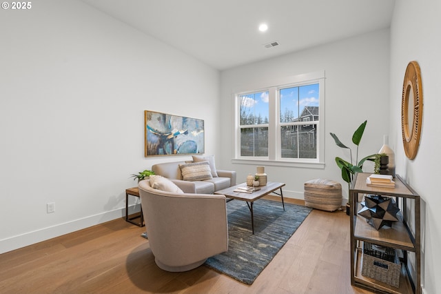 sitting room with hardwood / wood-style flooring