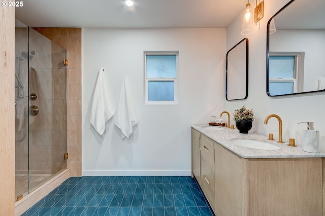 bathroom with plenty of natural light, vanity, a shower with door, and tile patterned flooring