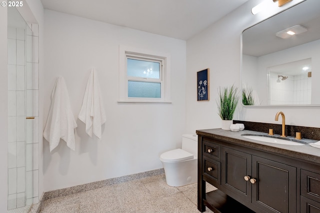 bathroom featuring a shower, vanity, and toilet