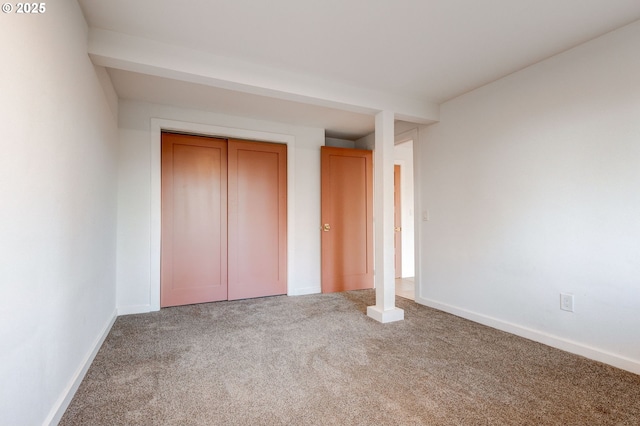 unfurnished bedroom featuring carpet flooring and a closet