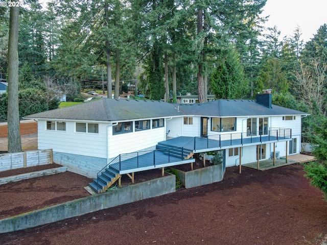 rear view of house with a wooden deck