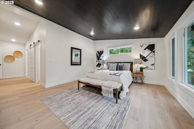 17253 SW Rivendell Dr, Portland, OR 97224 - bedroom with a barn door, light wood finished floors, recessed lighting, and wood ceiling