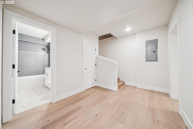 17253 SW Rivendell Dr, Portland, OR 97224 - below grade area with electric panel, light wood-style floors, stairway, and recessed lighting