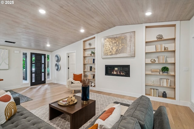 17253 SW Rivendell Dr, Portland, OR 97224 - living room featuring vaulted ceiling, built in shelves, wood ceiling, a glass covered fireplace, and light wood finished floors