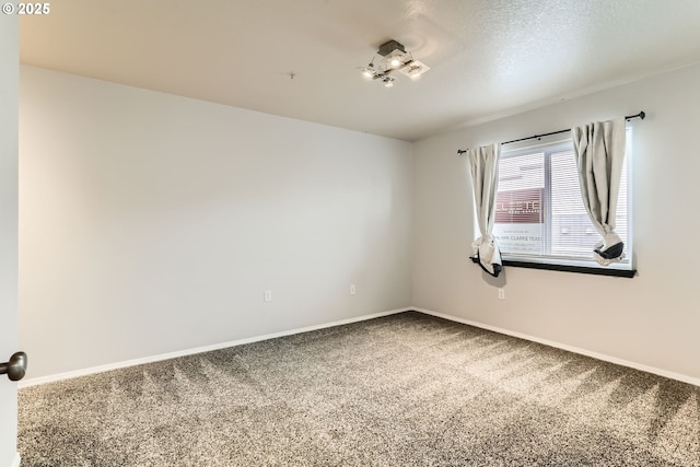 carpeted spare room with a textured ceiling