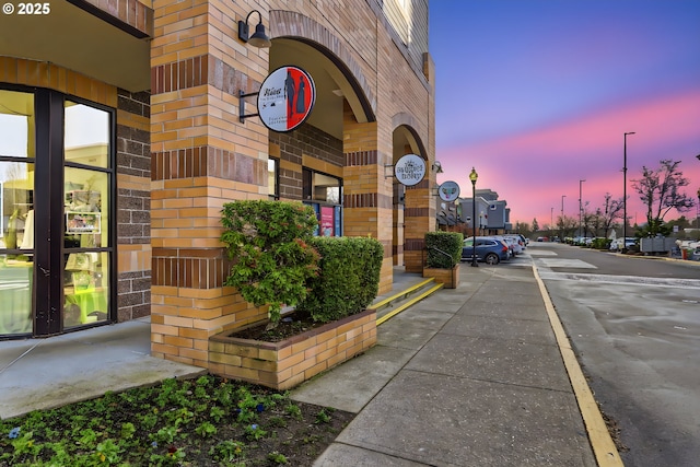 view of exterior entry at dusk