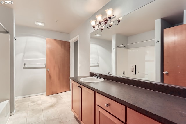 bathroom featuring tile patterned flooring, vanity, and walk in shower