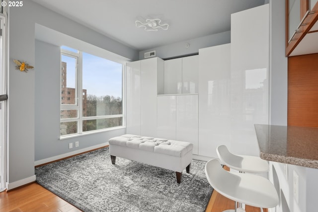 bathroom featuring visible vents, baseboards, and wood finished floors