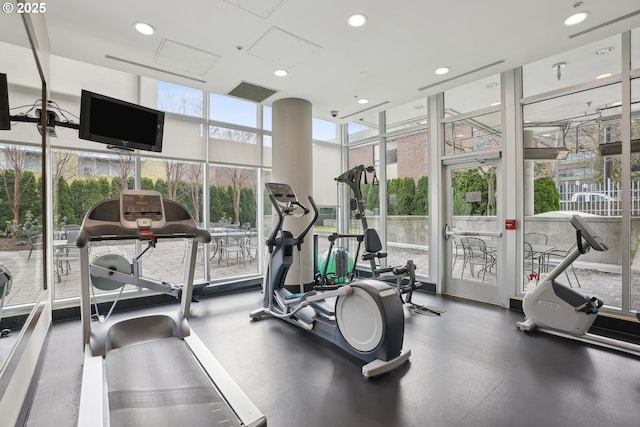 exercise room with recessed lighting and floor to ceiling windows